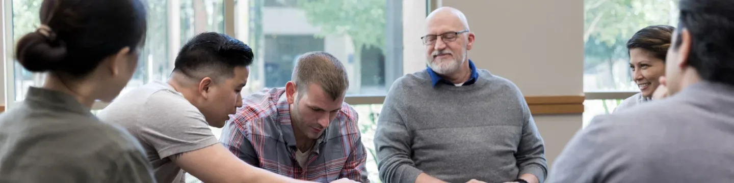 Group of people in a room discussing a topic
