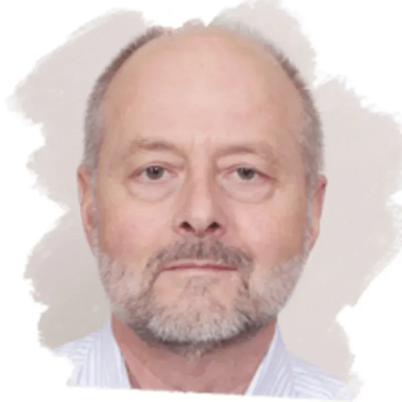 A senior man with short grey hair wearing a white and blue pinstriped shirt.