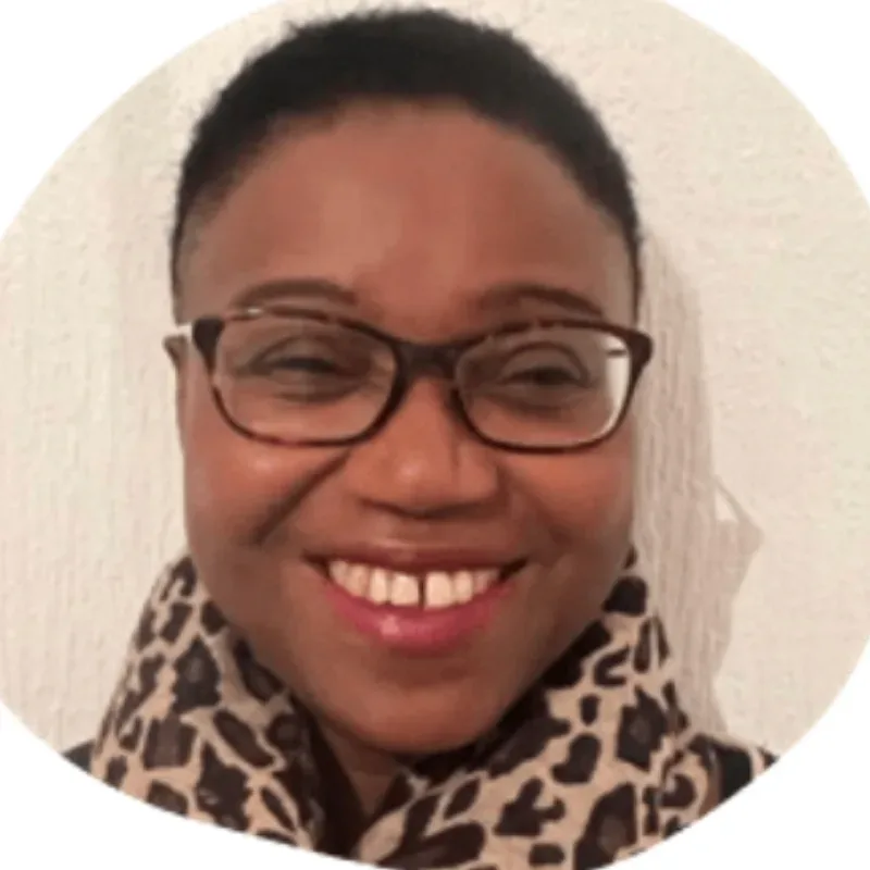 A woman wearing glasses and a leopard print scarf.