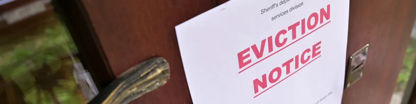 A notice of eviction was posted on a door, serving as a legal warning to the current tenants.