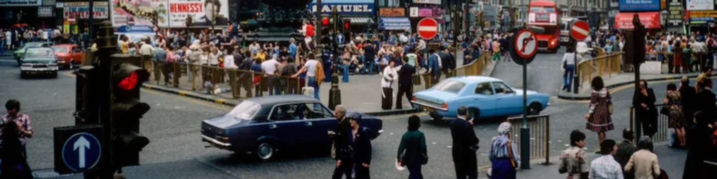 Typical London street in 1975 with people, bus and cars
