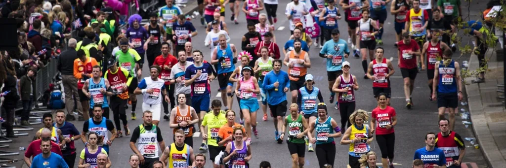 Lots of runners running in a marathon, overhead shot