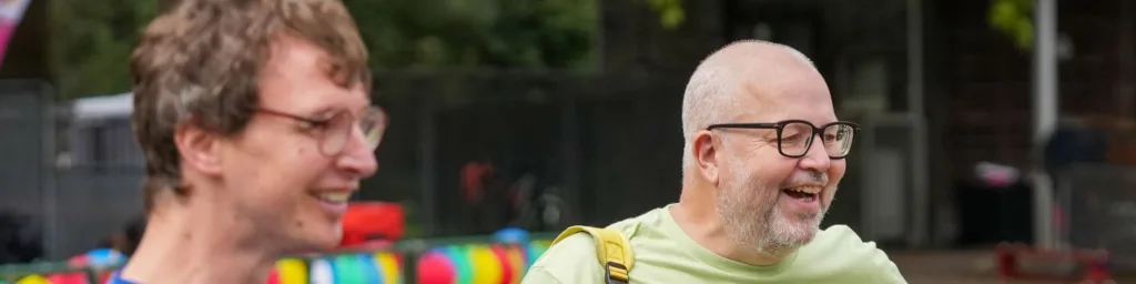 Two men at sports day smiling at events