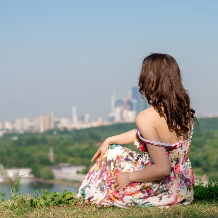 Girl on the background of the city landscape on the mountain