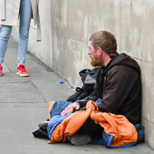Man with sleeping bag homeless on the street