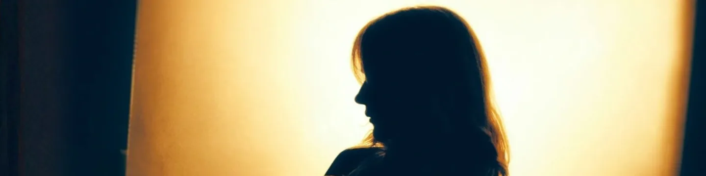 Side profile of woman in shadow
