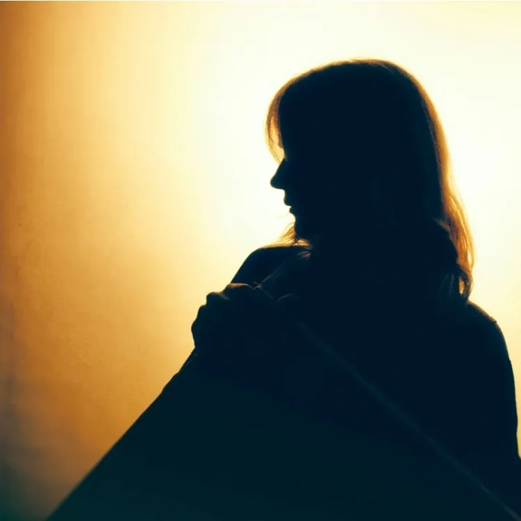 Side profile of woman in shadow
